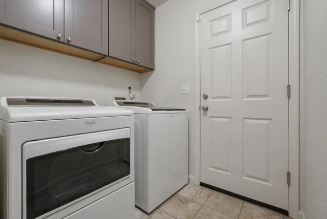 a view of a house with a yard and large tree