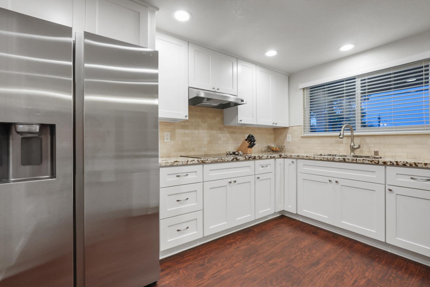 1820 North Berkeley Avenue Turlock, CA 95382 - Photo 9 of 29 a kitchen with granite countertop stainless steel appliances a sink and cabinets