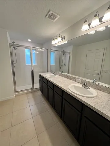 a white toilet sitting next to a white wall