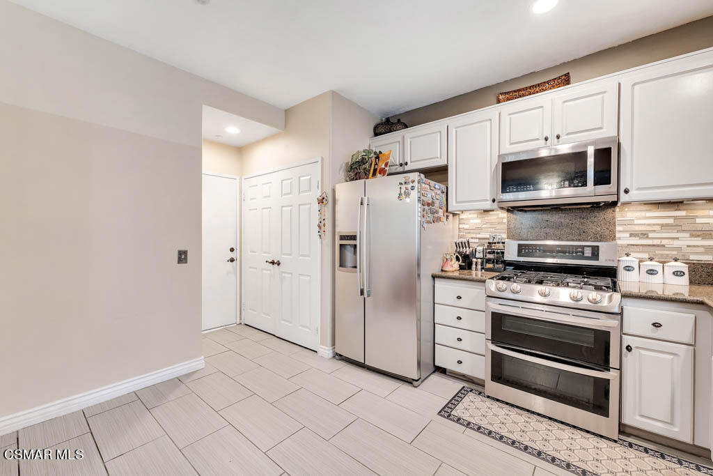 272 Springmist Lane Simi Valley, CA 93065 - Photo 11 of 47 a kitchen with stainless steel appliances a stove a microwave and a refrigerator