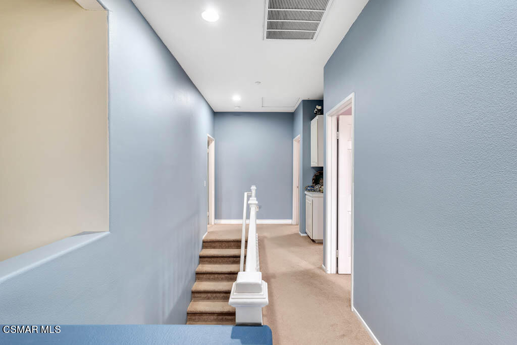 272 Springmist Lane Simi Valley, CA 93065 - Photo 23 of 47 a view of a hallway with white walls and stairs