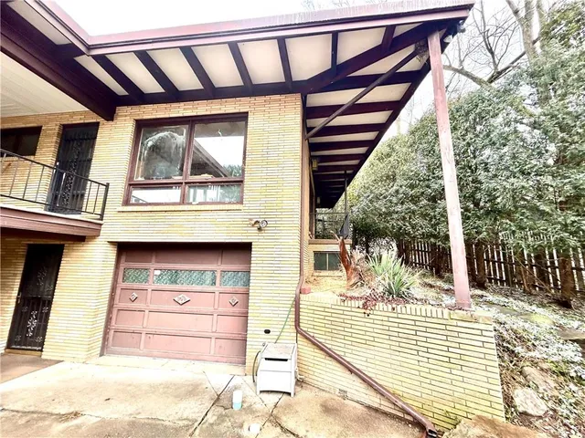 a view of a house with a snow on the road