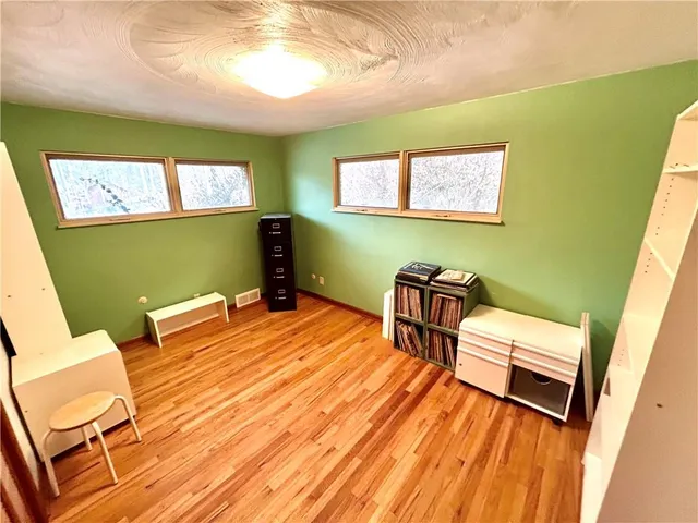 a view of a room with wooden floor and window