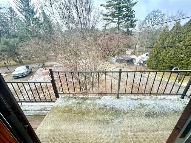 a dining room with furniture and a flat screen tv