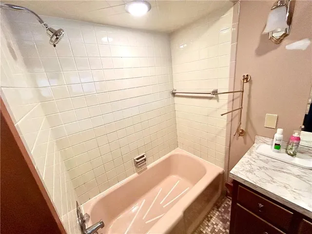 a kitchen with stainless steel appliances a sink a stove top oven a counter space and cabinets