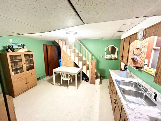 a bathroom with a toilet a sink a shower and a mirror