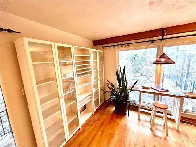 a view of living room with a floor to ceiling window and wooden floor