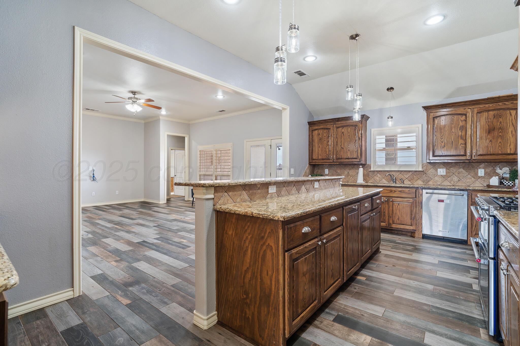 18451 Copper Ridge Bushland, TX 79124 - Photo 10 of 50 a large kitchen with stainless steel appliances granite countertop a large counter top and cabinets