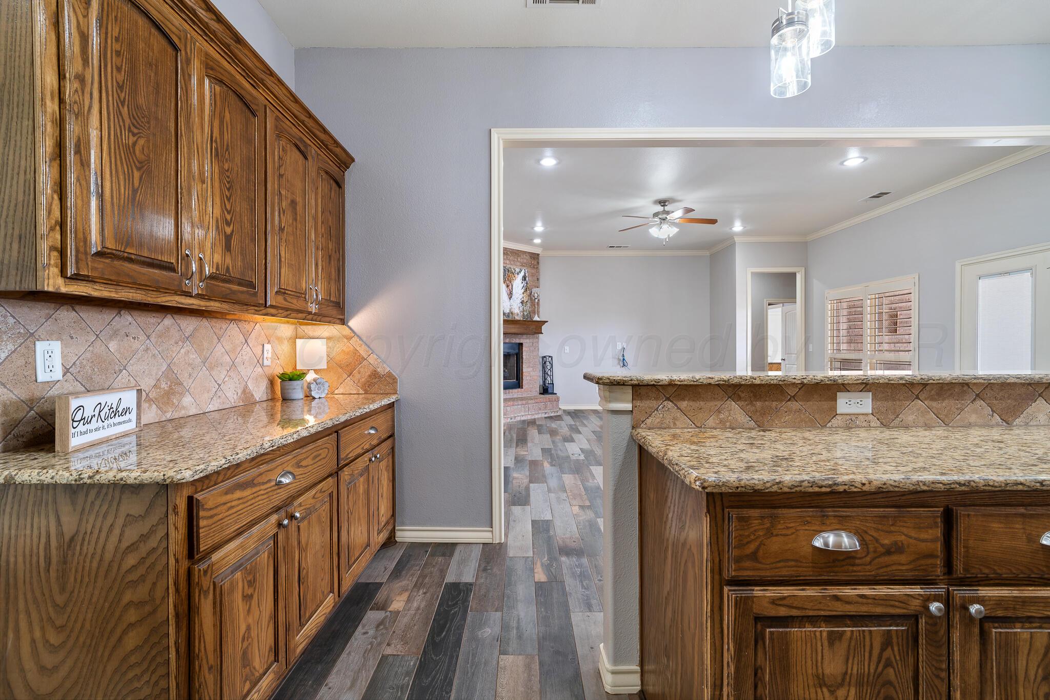 18451 Copper Ridge Bushland, TX 79124 - Photo 11 of 50 a kitchen with stainless steel appliances granite countertop a sink stove and cabinets