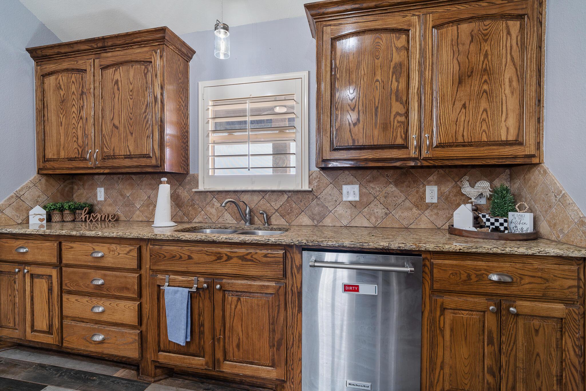 18451 Copper Ridge Bushland, TX 79124 - Photo 14 of 50 a kitchen with granite countertop wooden cabinets and a sink