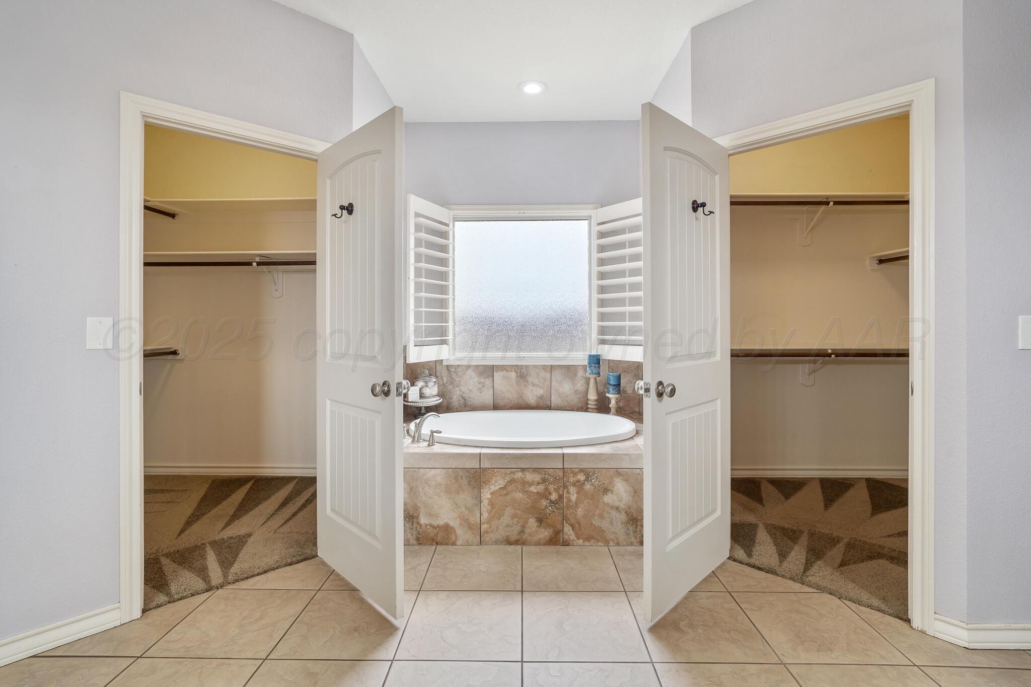 18451 Copper Ridge Bushland, TX 79124 - Photo 21 of 50 a spacious bathroom with a sink and a mirror