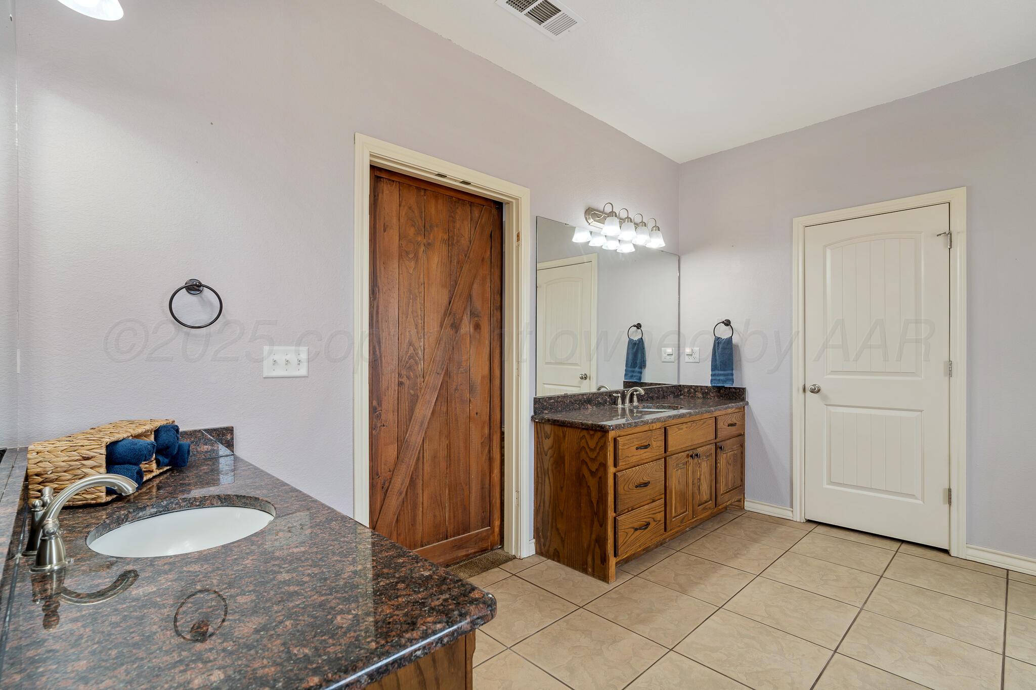 18451 Copper Ridge Bushland, TX 79124 - Photo 24 of 50 a spacious bathroom with a granite countertop double vanity sink mirror and