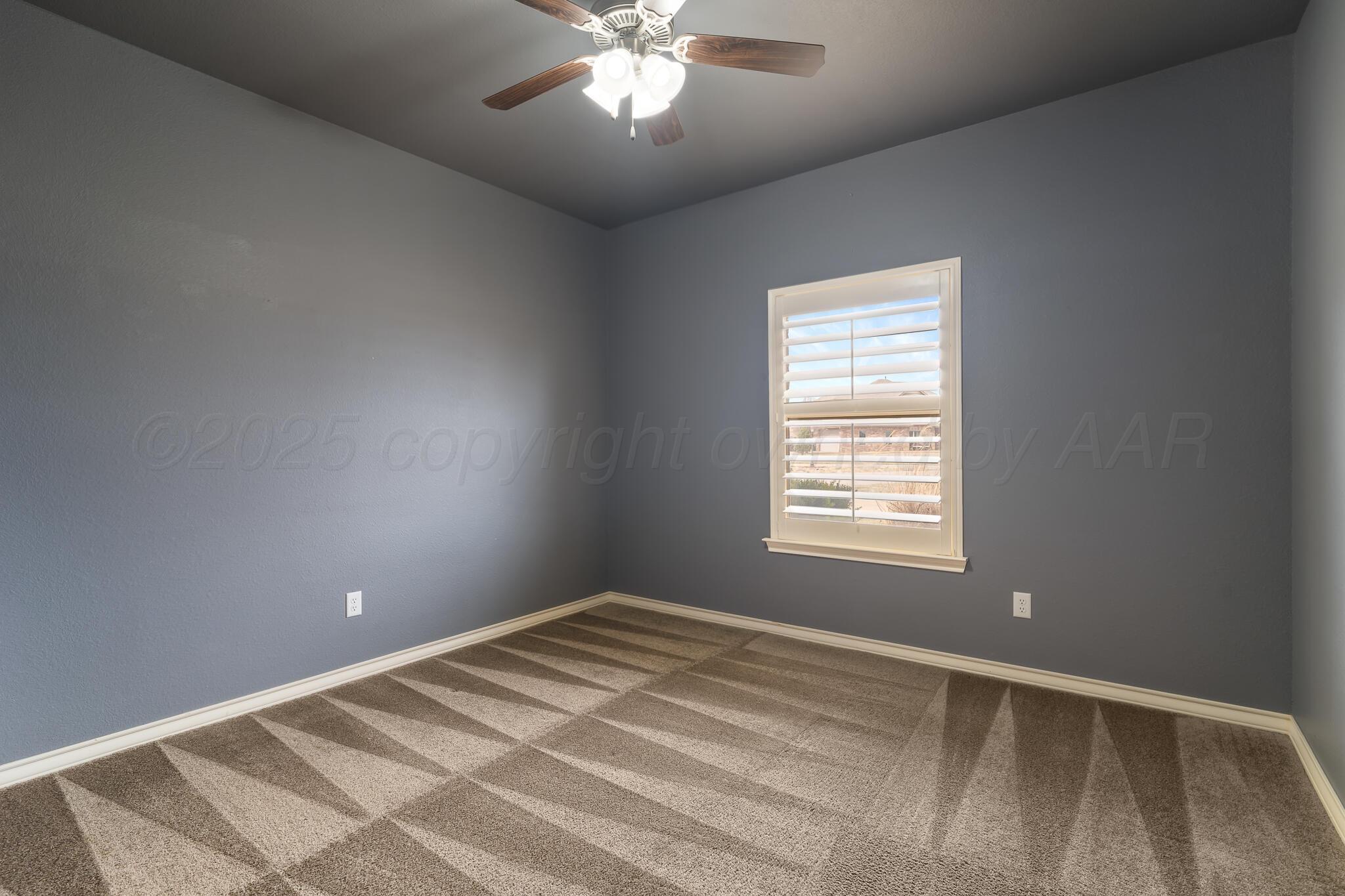 18451 Copper Ridge Bushland, TX 79124 - Photo 27 of 50 a view of a bedroom with a ceiling fan and a window