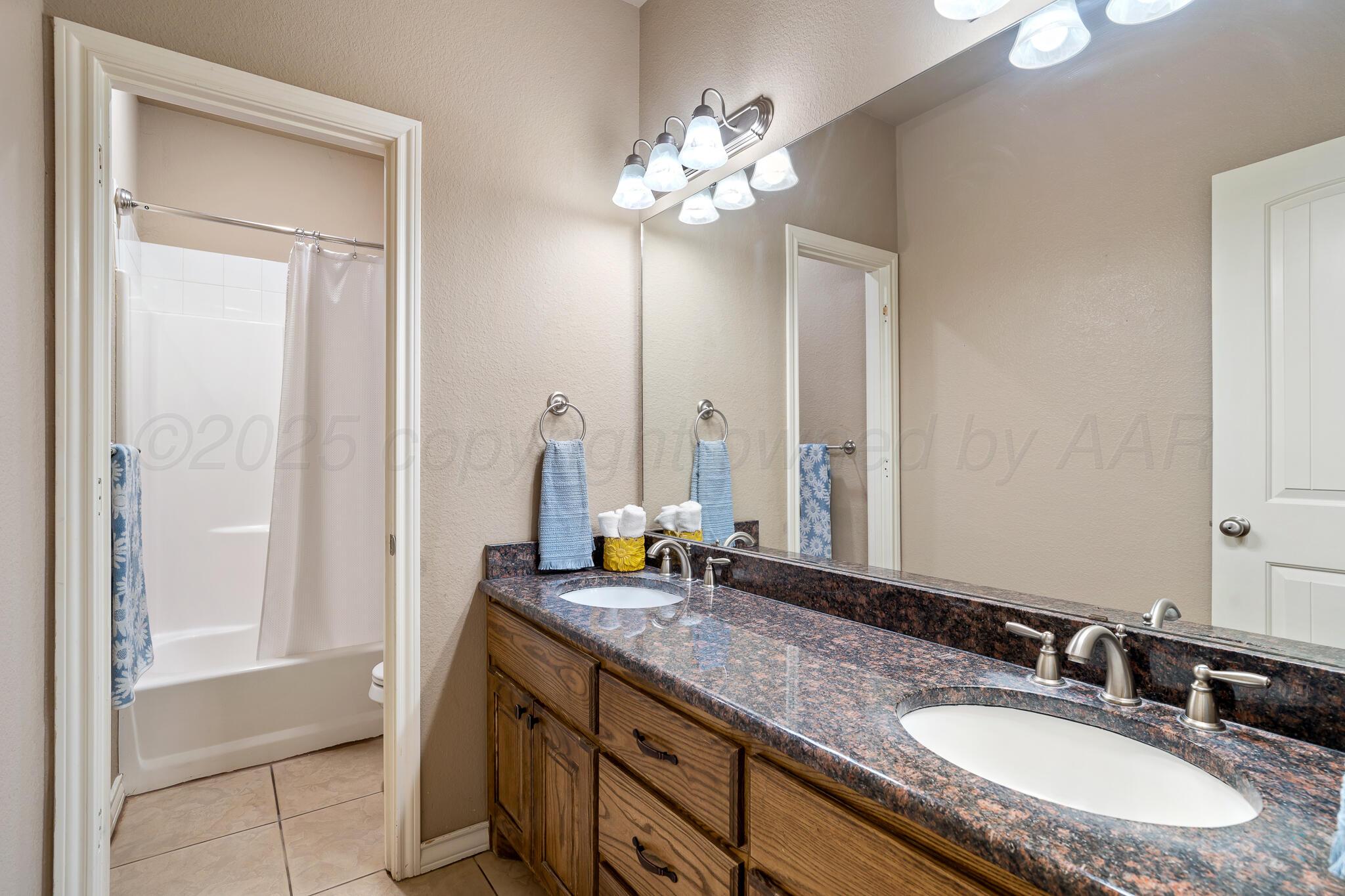 18451 Copper Ridge Bushland, TX 79124 - Photo 30 of 50 a bathroom with a granite countertop sink and a mirror