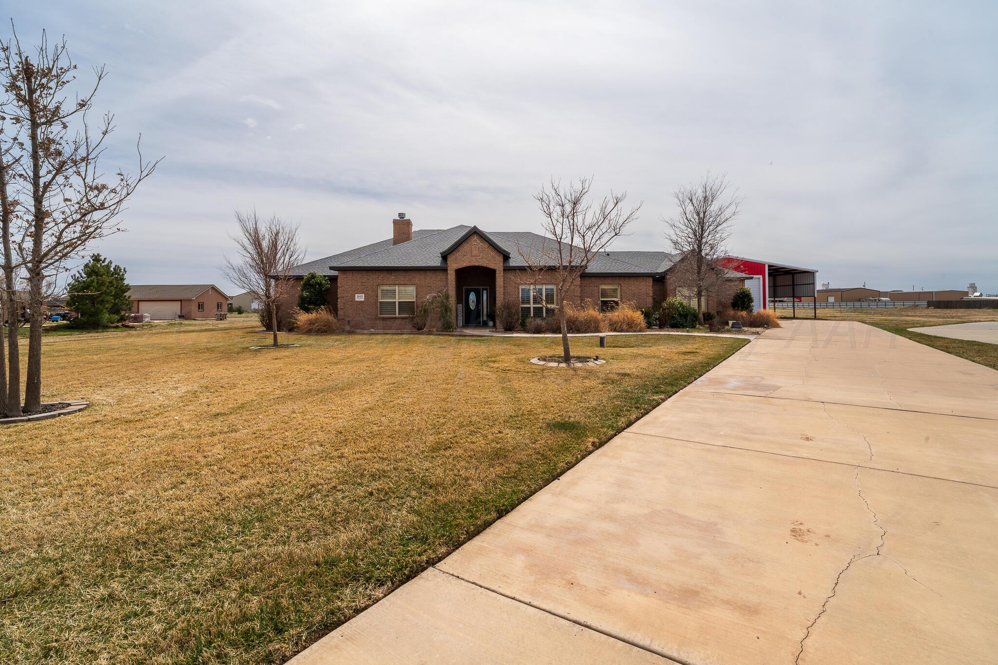 18451 Copper Ridge Bushland, TX 79124 - Photo 4 of 50 a front view of house with yard and trees around