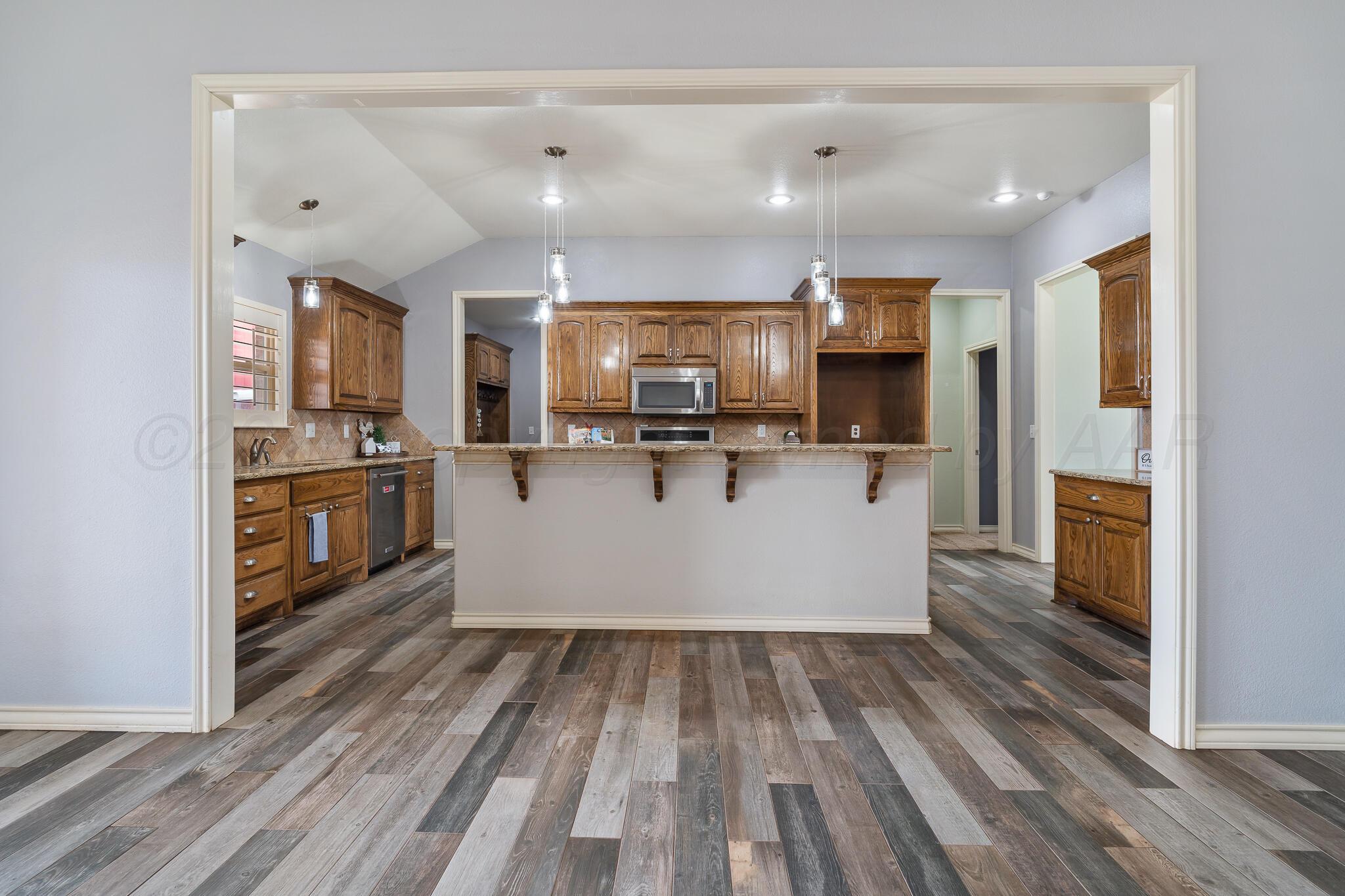 18451 Copper Ridge Bushland, TX 79124 - Photo 9 of 50 a view of kitchen with cabinets microwave and stove