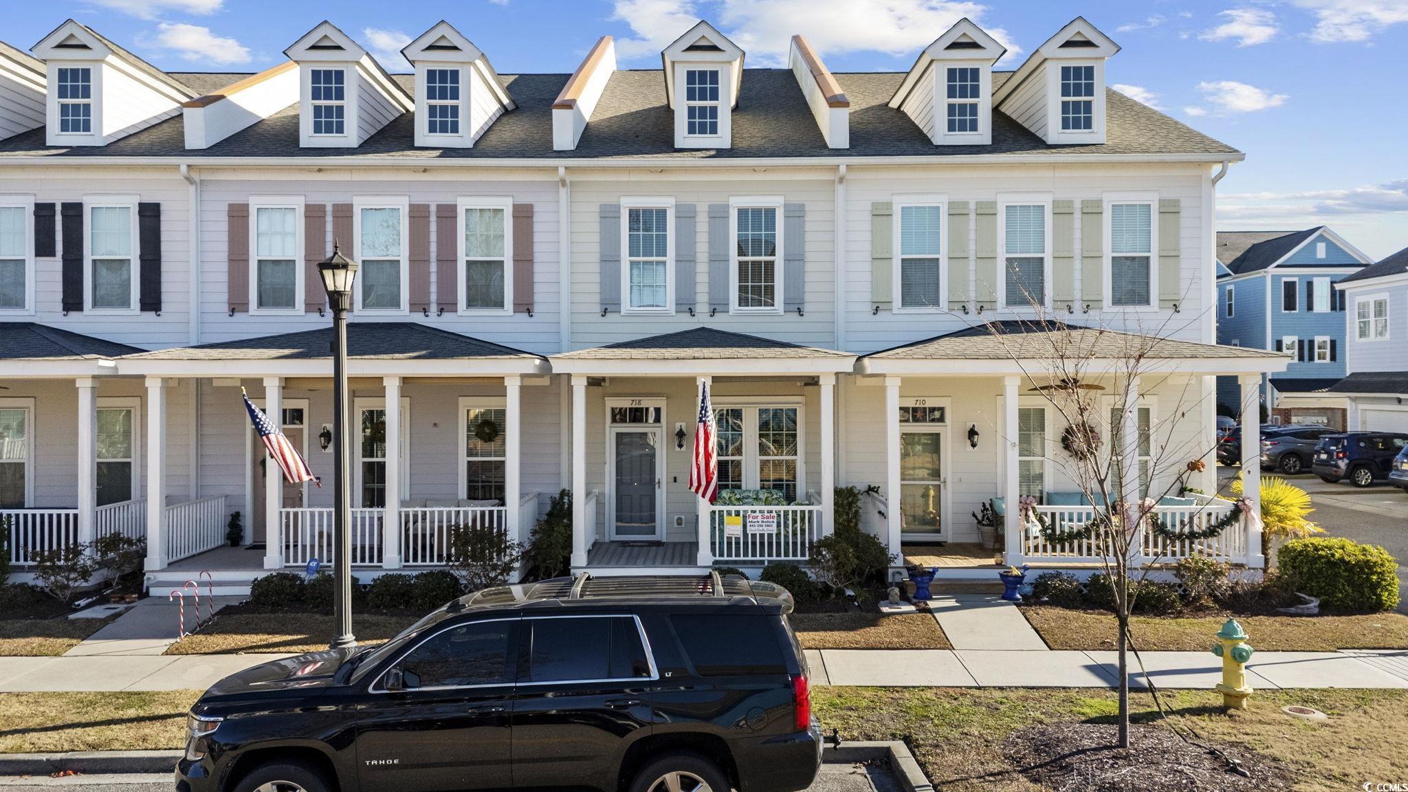 View of front of house featuring a porch and a shingled roof