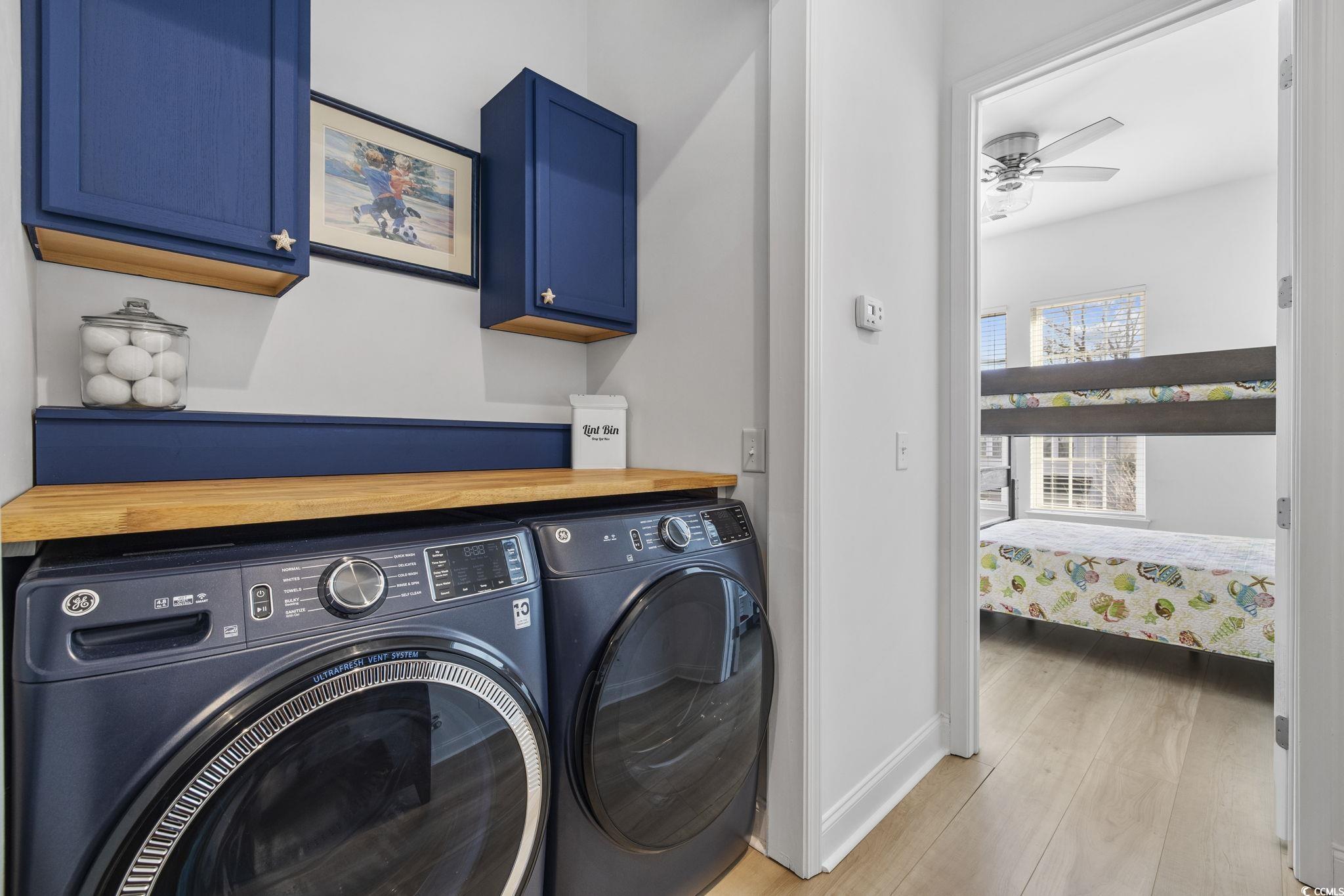 718 Shine Avenue, Unit 718 Myrtle Beach, SC 29577 - Photo 20 of 36 Laundry area featuring cabinet space, hardwood / wood-style flooring, separate washer and dryer, and ceiling fan