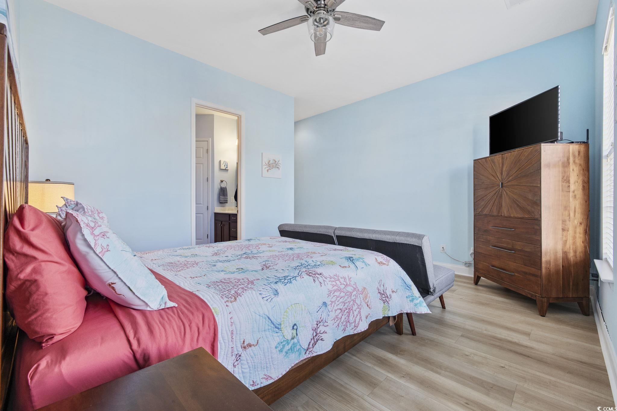 718 Shine Avenue, Unit 718 Myrtle Beach, SC 29577 - Photo 22 of 36 Bedroom featuring wood finished floors, ensuite bathroom, and ceiling fan