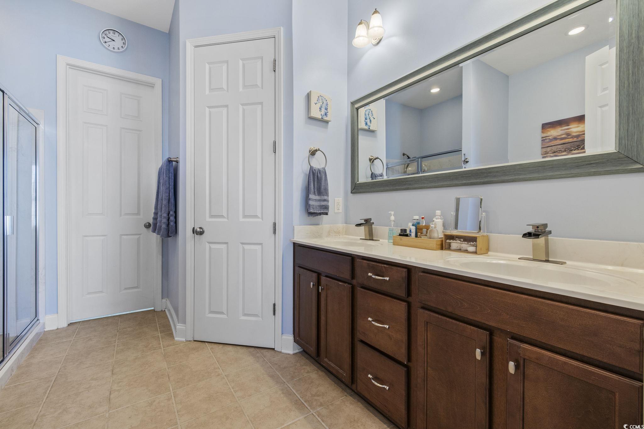 718 Shine Avenue, Unit 718 Myrtle Beach, SC 29577 - Photo 23 of 36 Full bathroom with double vanity, light tile patterned flooring, a stall shower, and recessed lighting