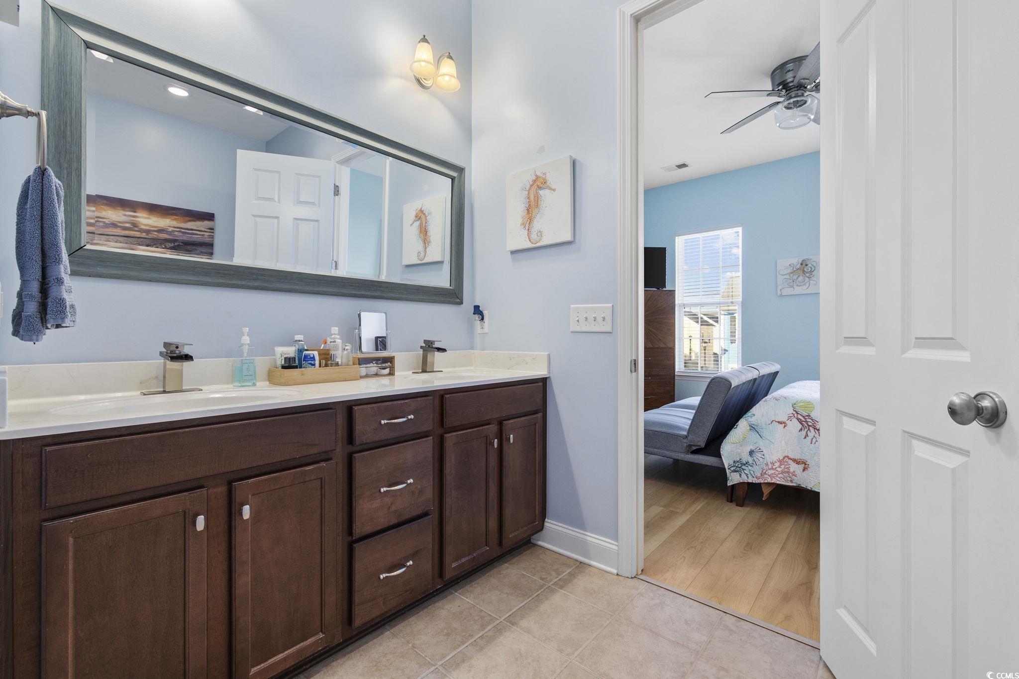718 Shine Avenue, Unit 718 Myrtle Beach, SC 29577 - Photo 24 of 36 Ensuite bathroom with double vanity, ceiling fan, and light tile patterned flooring
