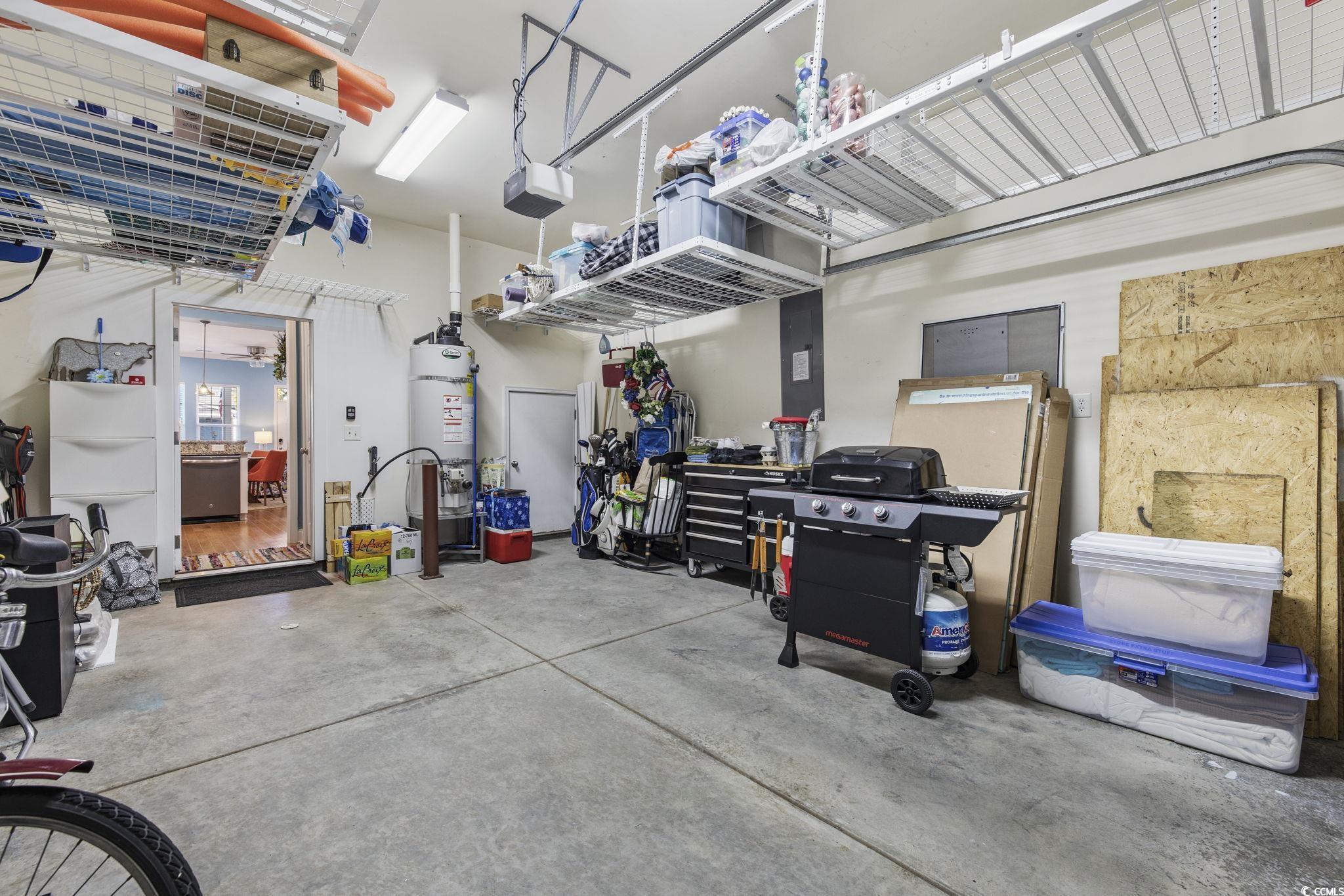 718 Shine Avenue, Unit 718 Myrtle Beach, SC 29577 - Photo 31 of 36 Garage featuring secured water heater and a garage door opener