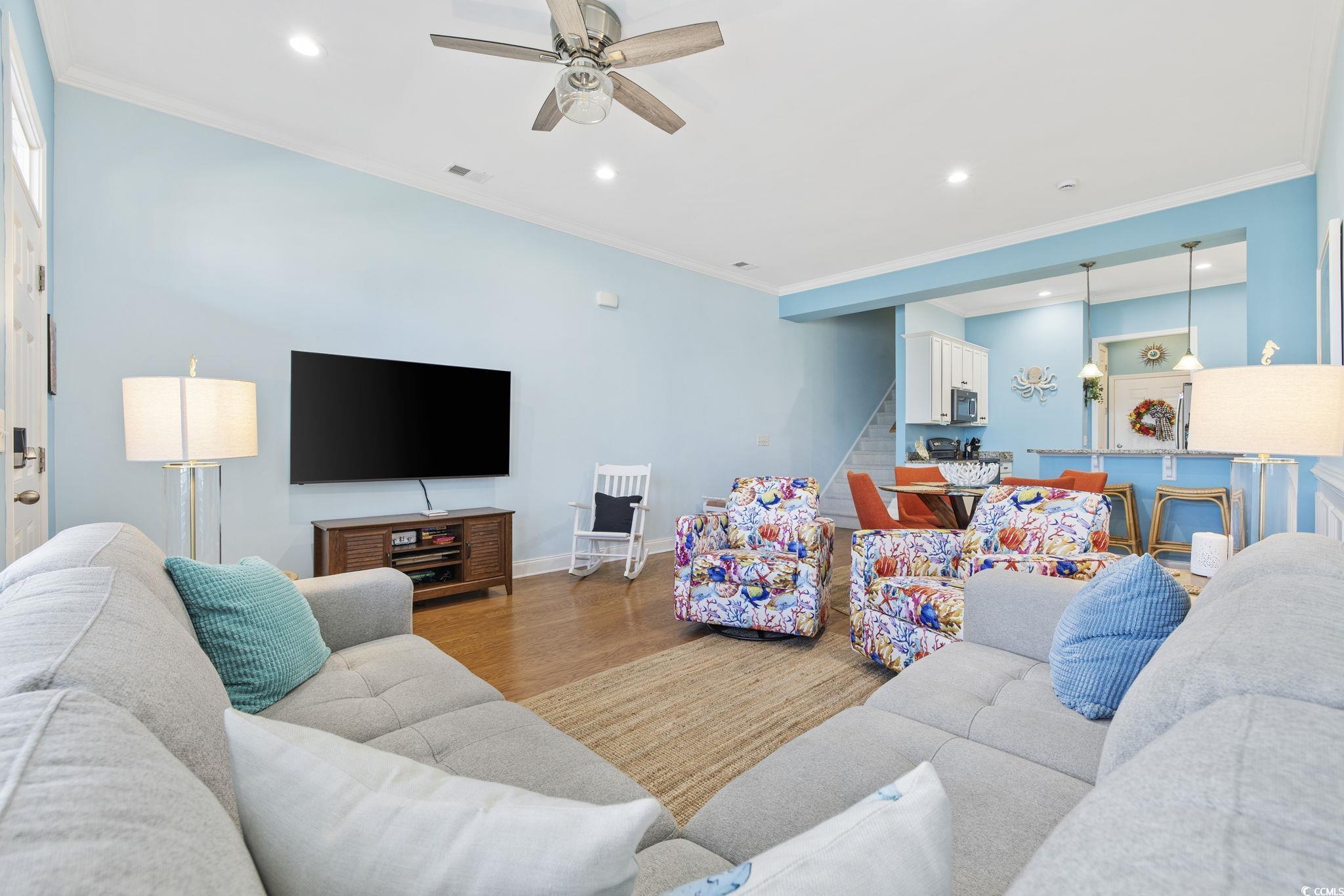 718 Shine Avenue, Unit 718 Myrtle Beach, SC 29577 - Photo 7 of 36 Living room featuring recessed lighting, ornamental molding, wood finished floors, stairway, and a ceiling fan