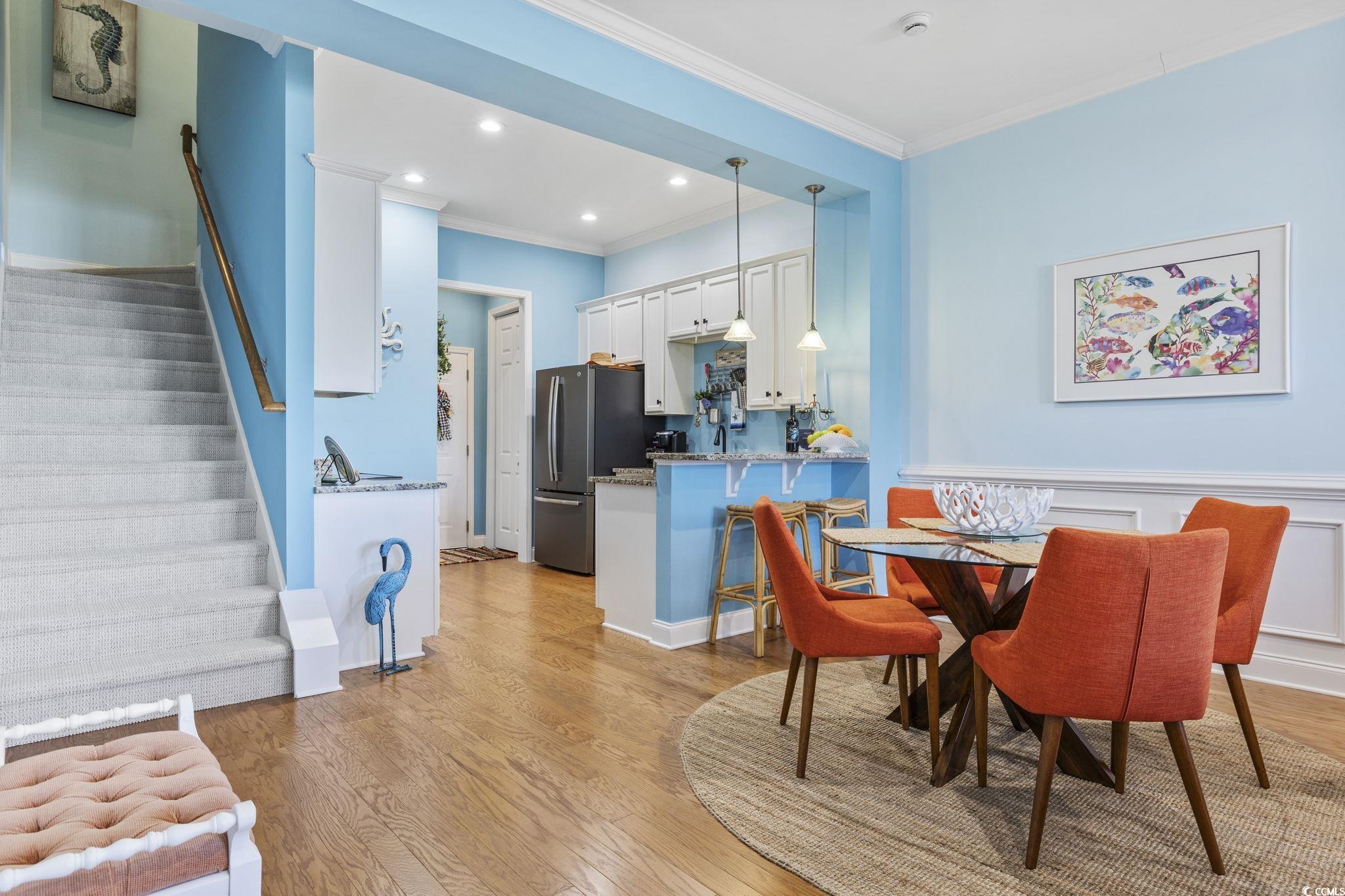 718 Shine Avenue, Unit 718 Myrtle Beach, SC 29577 - Photo 10 of 36 Dining space with stairs, light wood-style floors, crown molding, and recessed lighting