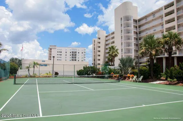 a view of swimming pool with outdoor seating and plants