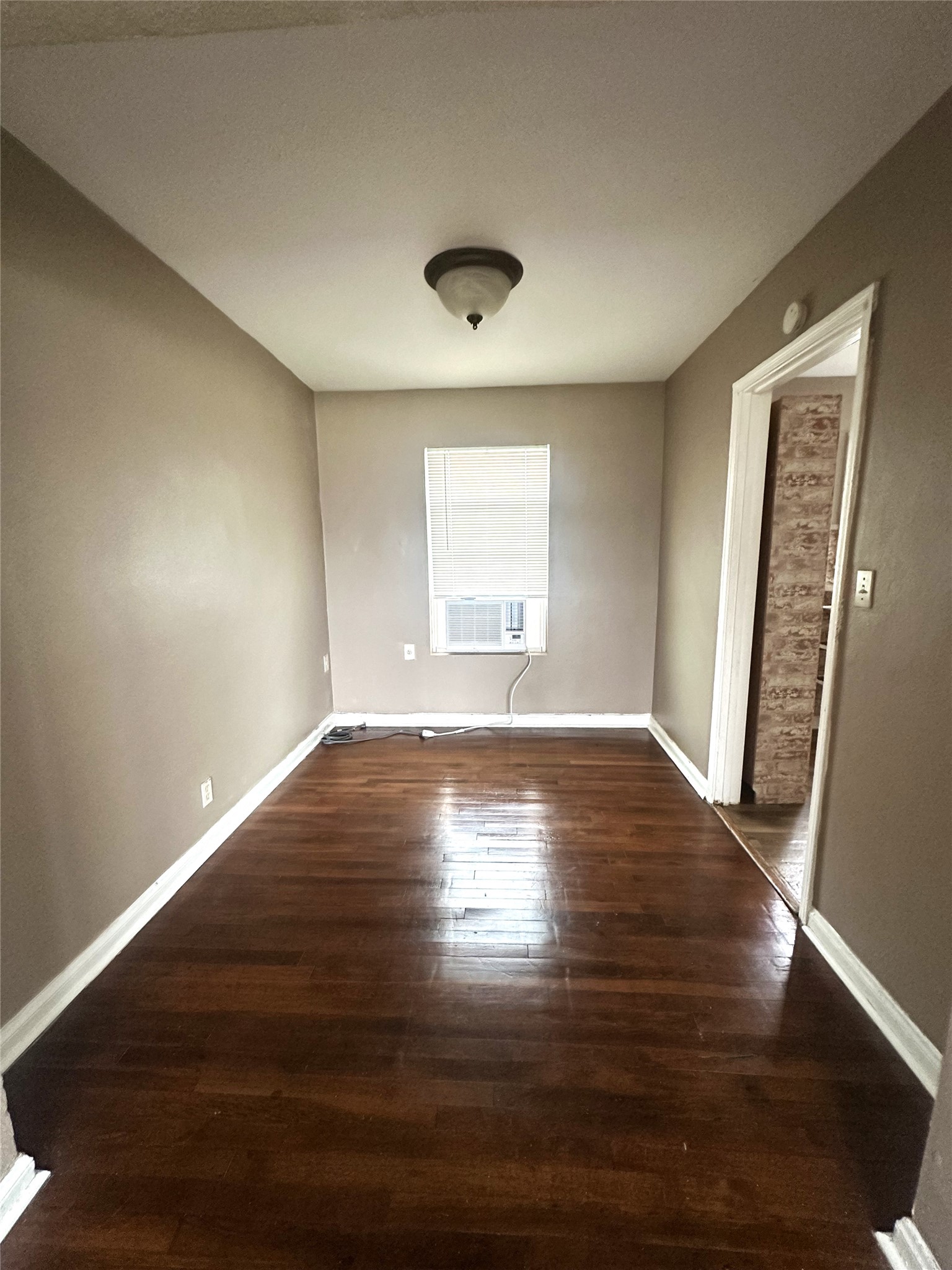 11005 Muscatine Street Houston, TX 77029 - Photo 5 of 12 a view of empty room with wooden floor and fan