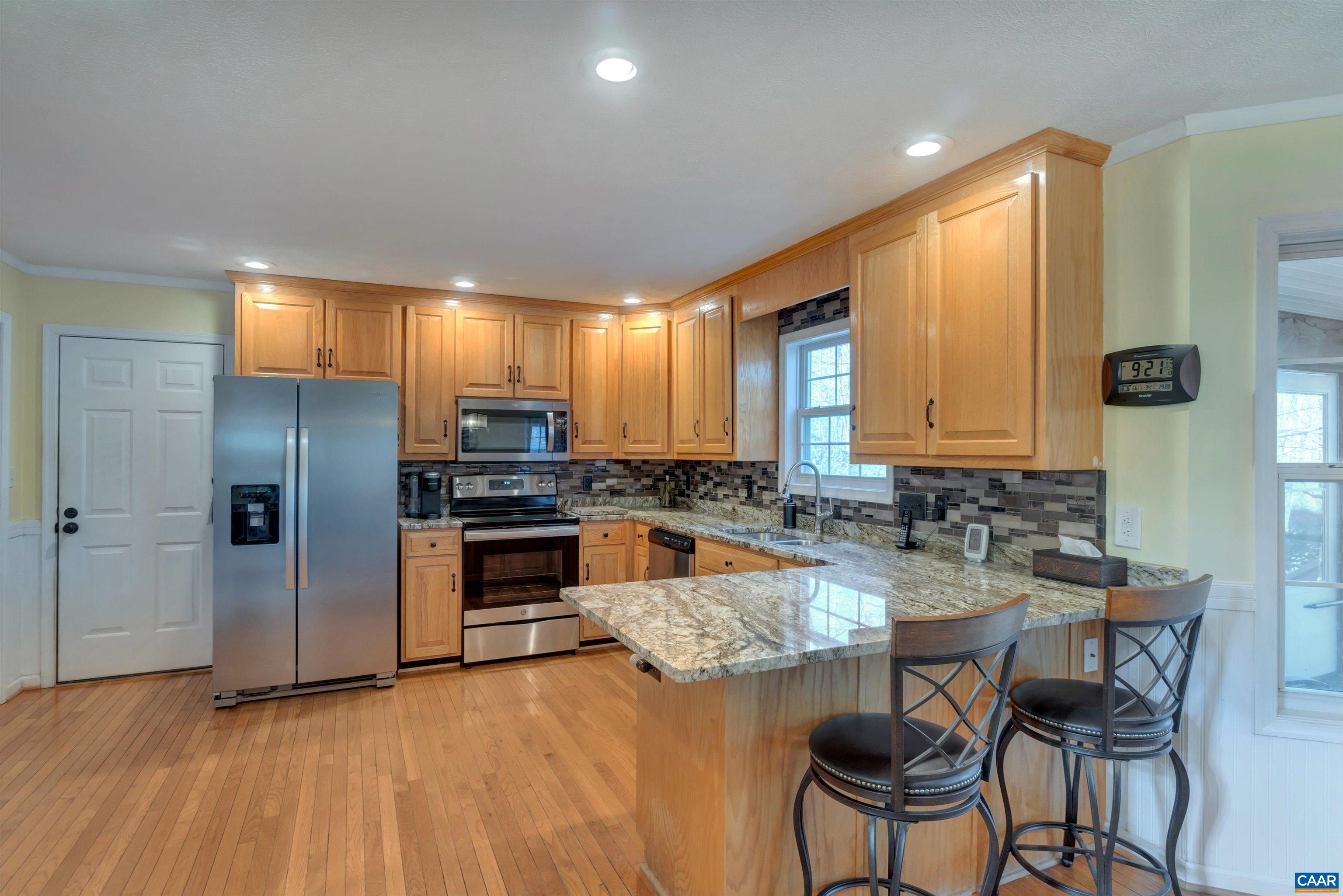 222 Starcrest Road Charlottesville, VA 22902 - Photo 15 of 46 a kitchen with refrigerator a sink and chairs