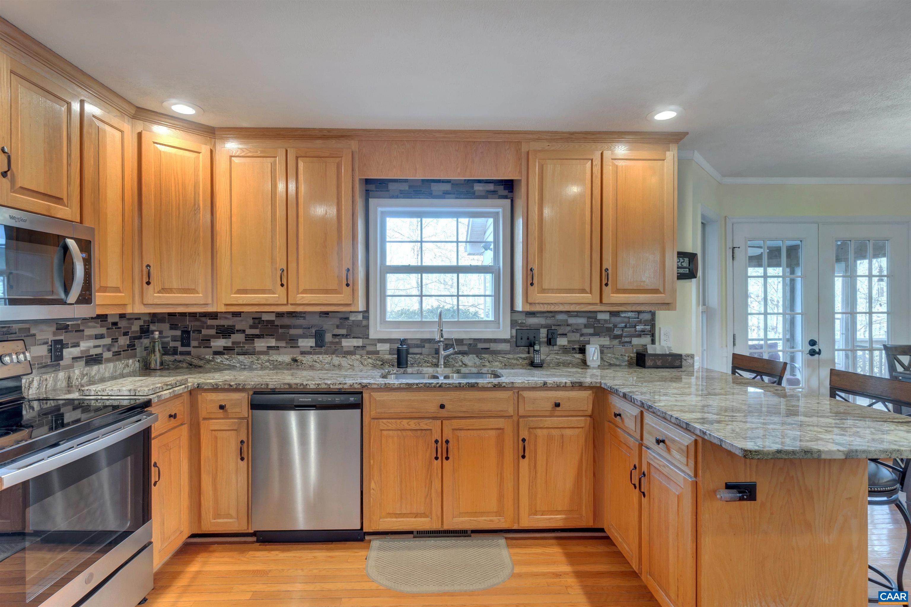 222 Starcrest Road Charlottesville, VA 22902 - Photo 16 of 46 a kitchen with stainless steel appliances granite countertop a sink stove and cabinets