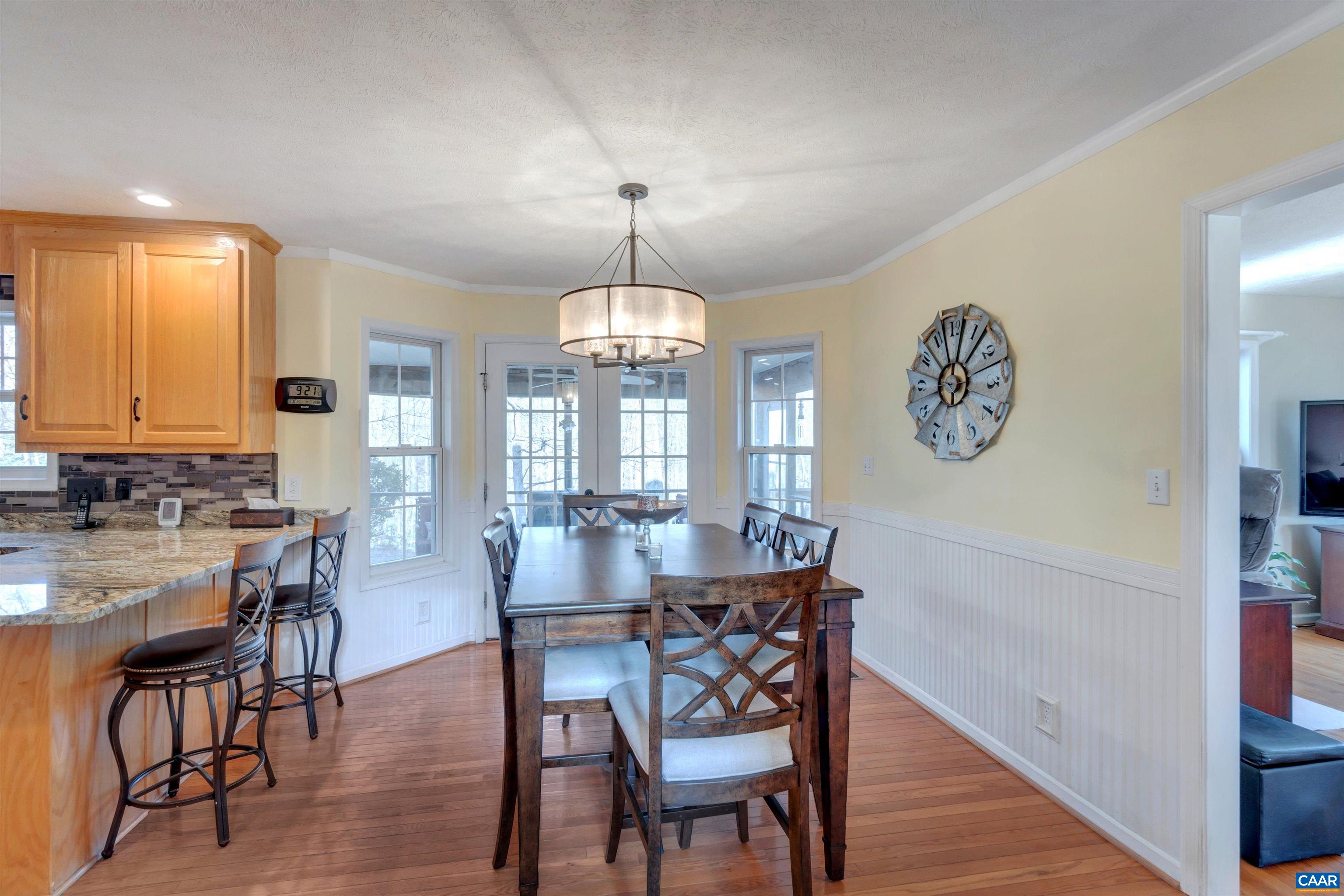 222 Starcrest Road Charlottesville, VA 22902 - Photo 18 of 46 a view of a dining room with furniture window and wooden floor