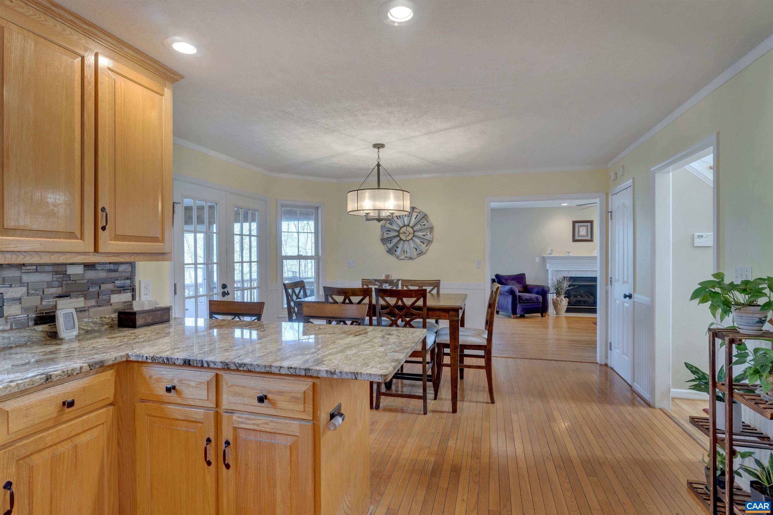 222 Starcrest Road Charlottesville, VA 22902 - Photo 19 of 46 a view of a kitchen area with granite countertop stainless steel appliances refrigerator dining table and chairs