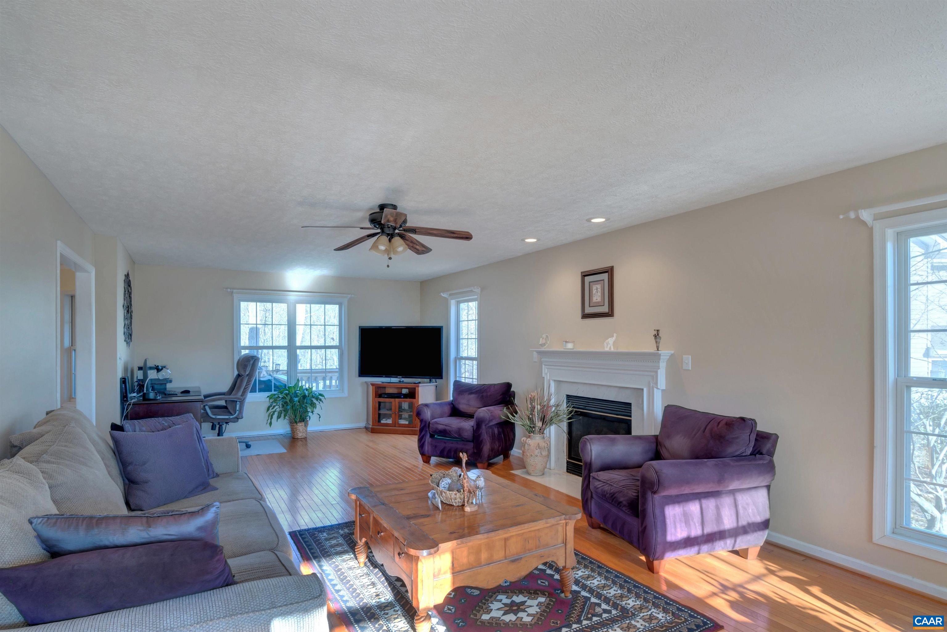 222 Starcrest Road Charlottesville, VA 22902 - Photo 10 of 46 a living room with furniture a fireplace and a flat screen tv