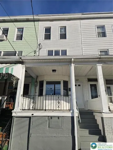 a view of a house with wooden deck