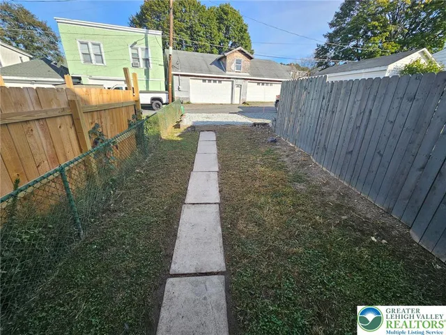 a view of a pathway with a backyard