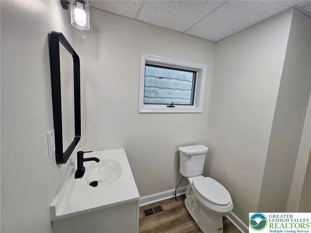 a bathroom with a toilet sink and mirror