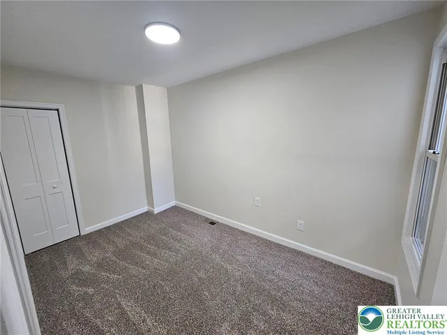 a view of an empty room and a window