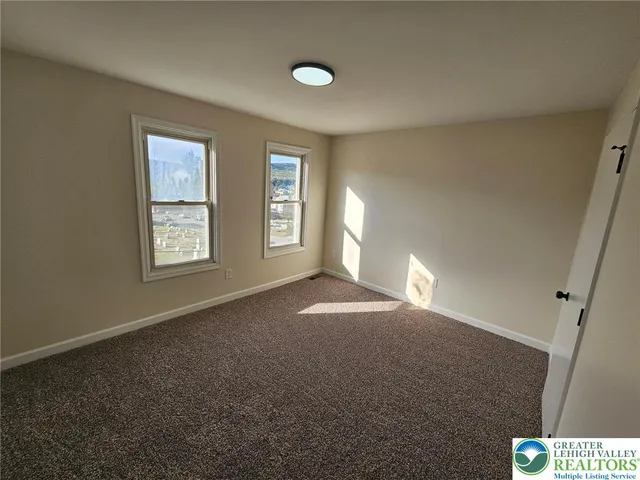 a view of empty room with windows