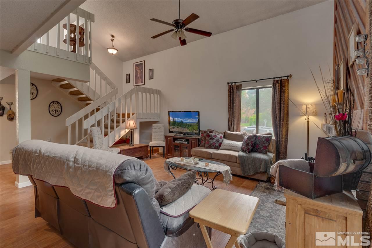 1661 Foster Drive Reno, NV 89509 - Photo 3 of 17 a living room with furniture and a chandelier