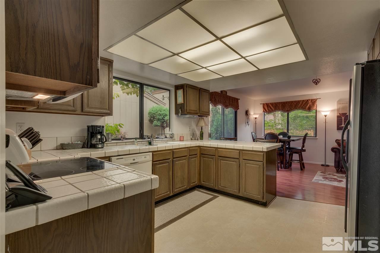 1661 Foster Drive Reno, NV 89509 - Photo 5 of 17 a kitchen with sink cabinets and dining table chair