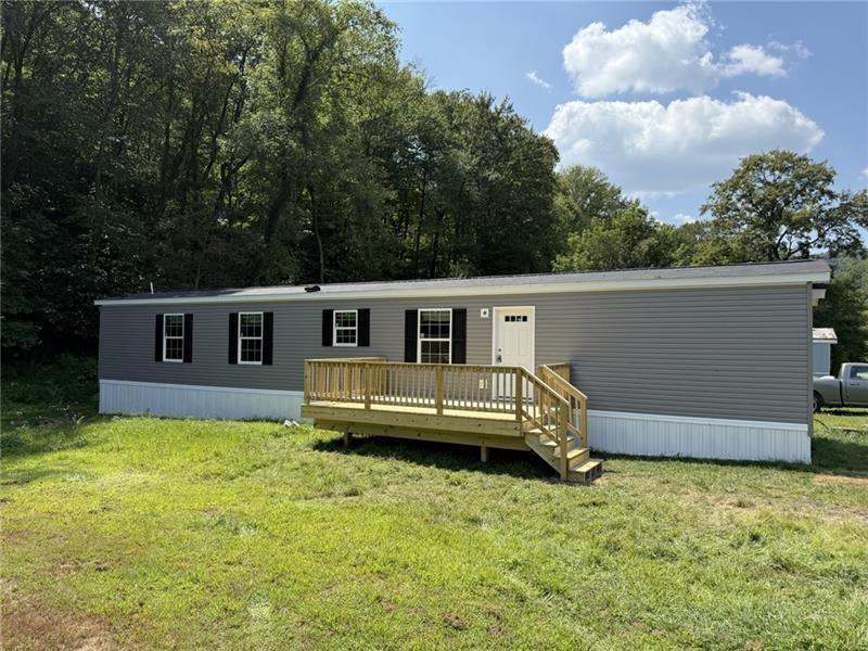 206 Iron Furnace Road East Brady, PA 16028 - Photo 1 of 15 a front view of a house with a garden