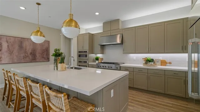 a kitchen with a sink a counter space and cabinets