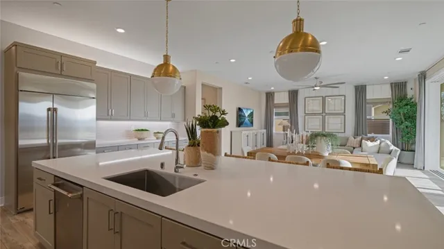 a kitchen with kitchen island a sink appliances and a counter top space