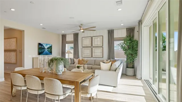 a dining room with furniture window and wooden floor