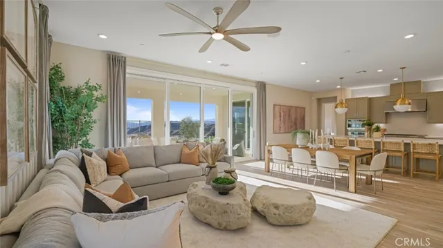 a living room with furniture and a large window with wooden floor