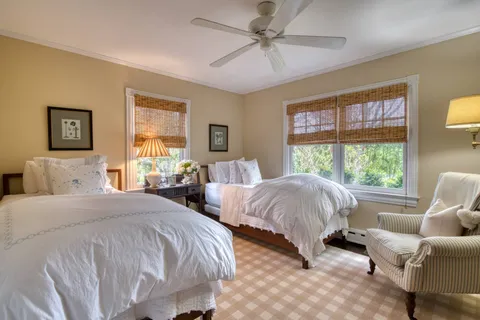 a spacious bedroom with two beds and a large window