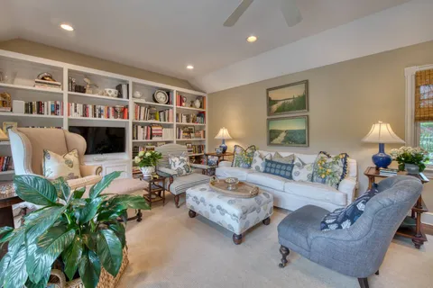 a living room with furniture and a bookshelf