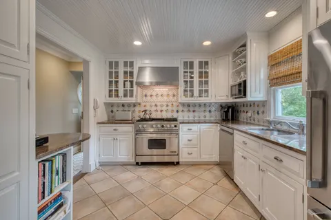 a kitchen with stainless steel appliances granite countertop a stove and a sink